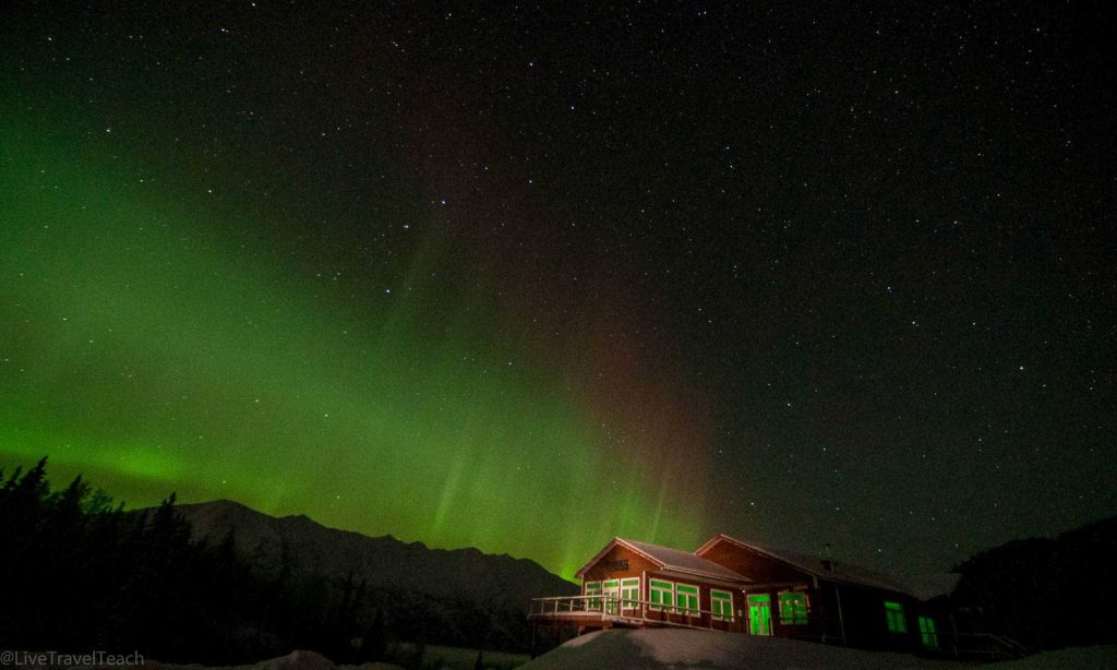 Green bands dancing over Knik River Lodge in Palmer, Alaska.