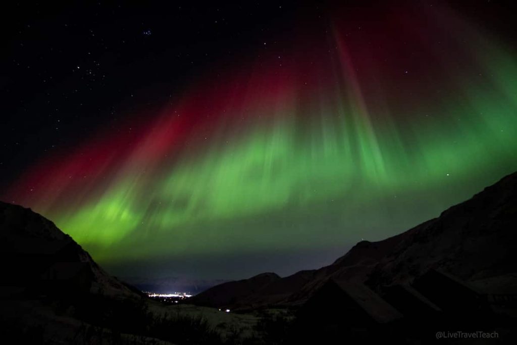 Chasing The Northern Lights Aurora borealis glowing over Hatcher Pass mountains in Alaska at night