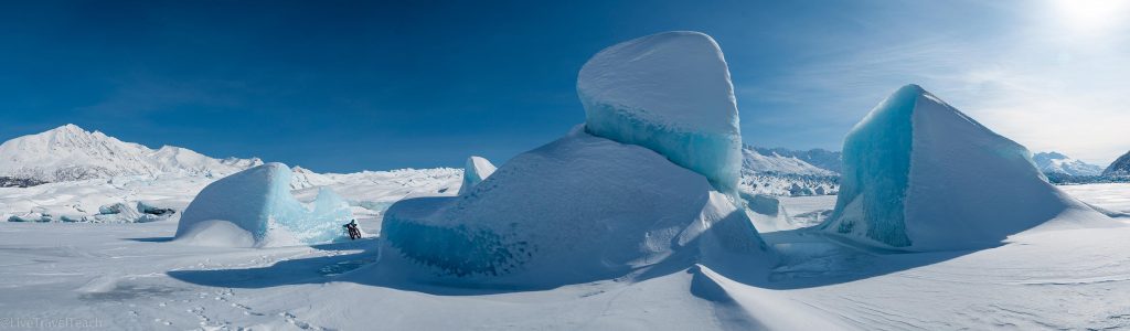 blue ice formations on the frozen lake surface in front of the Knik Glacier in Alaska