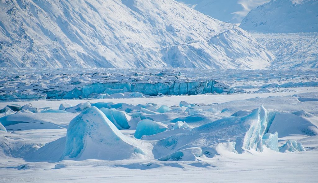 winter view of the massive blue icebergs and snow-covered formations at the terminus of Knik Glacier, Alaska