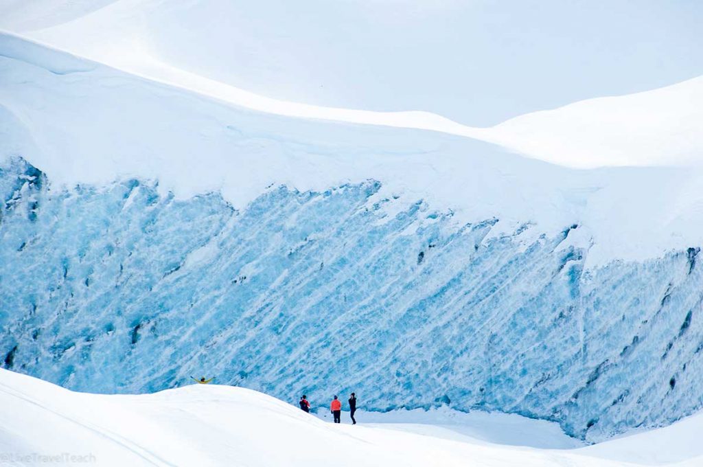 Skookum Glacier visitors exploring the stunning blue ice of Skookum Glacier