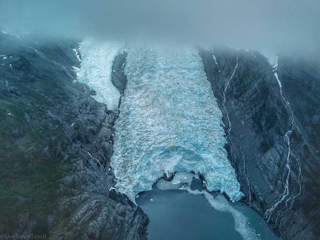 Beloit Glacier actively calving as large ice chunks sprayed ocean water high into the air