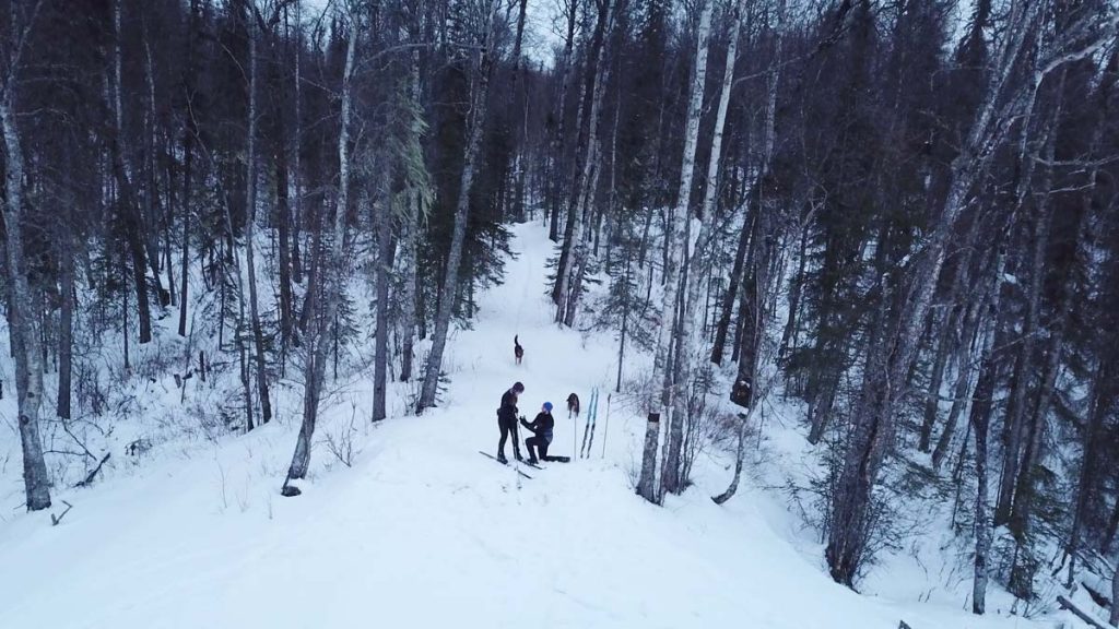 Alaska proposal taking place in a snowy, forested area in Alaska