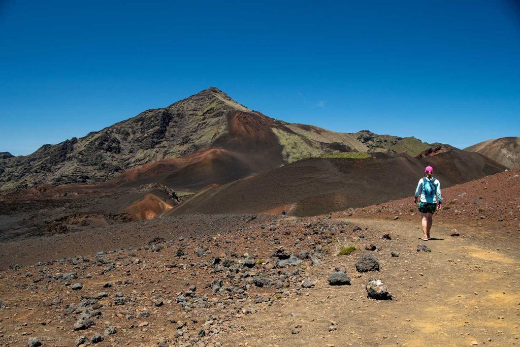 Hiking in Haleakala a hiker on the Sliding Sands Trail inside the Haleakalā National Park