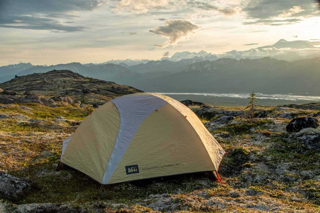 backpacking tent set up on a rocky tundra with a mountain view
