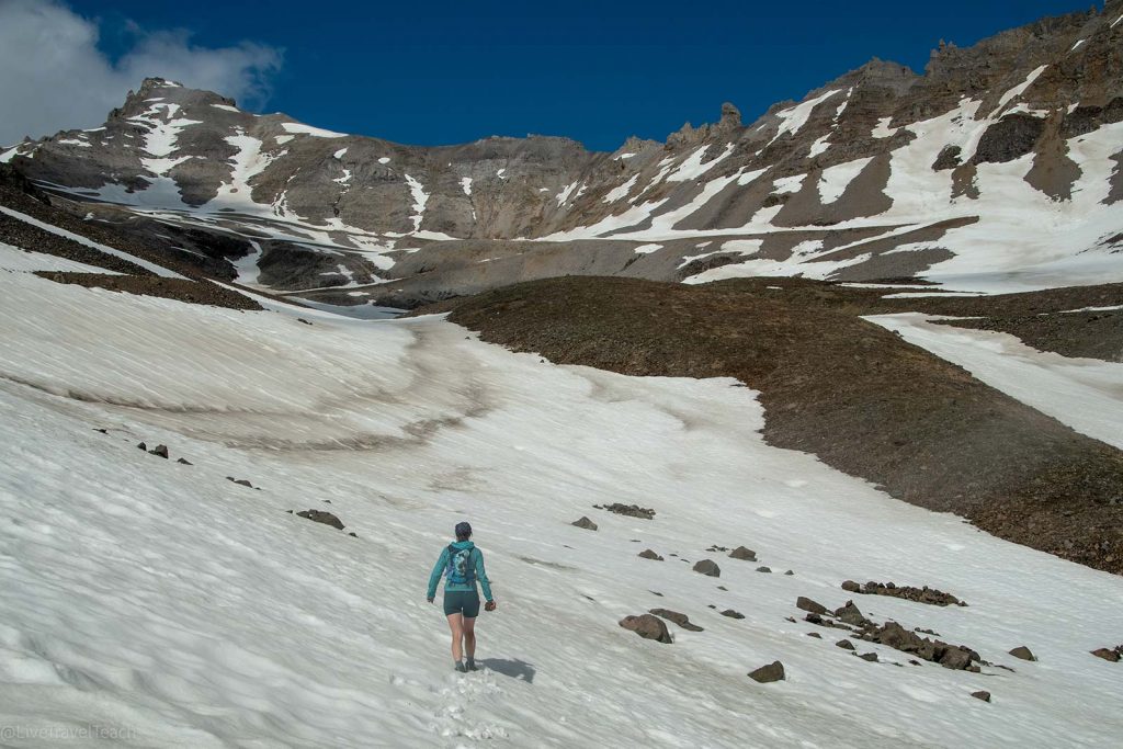 hiker walking on snowy trails