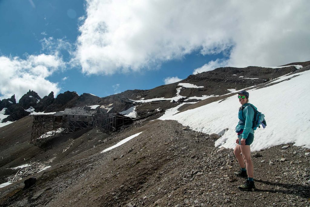 hiker exploring the historic Bonanza Mine ruins in Wrangell-St. Elias National Park and Preserve