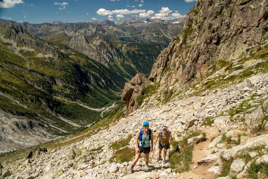 two hikers navigating the rocky terrain of the Arpette Pass