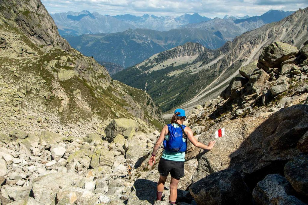 a hiker traversing the Fen&ecirc;tre d'Arpette pass on the Tour du Mont Blanc trail