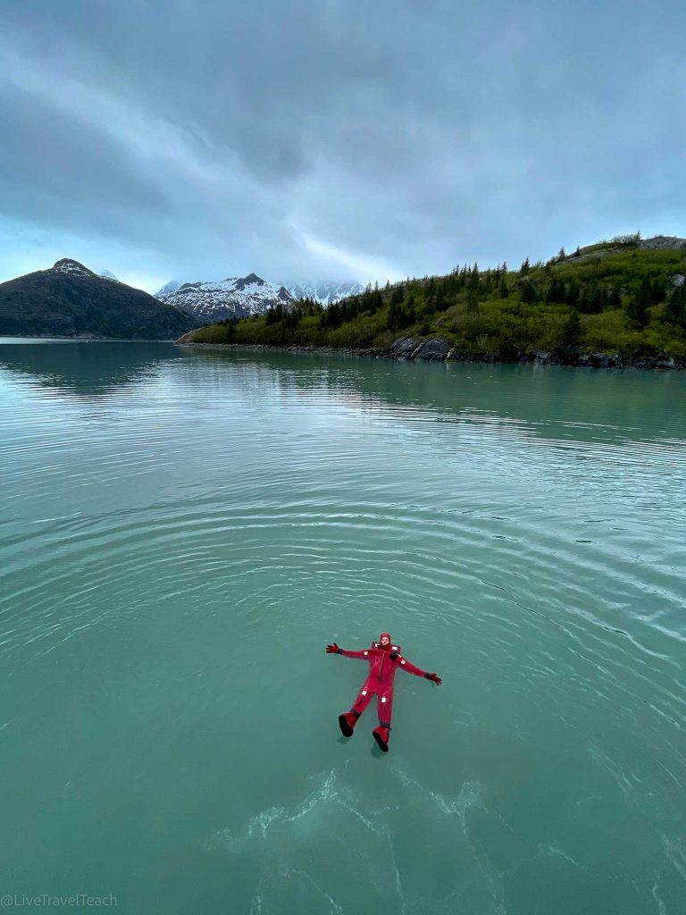 Kenai Fjords Kayak Mike Still wearing an immersion suit and floating relaxed on the icy water