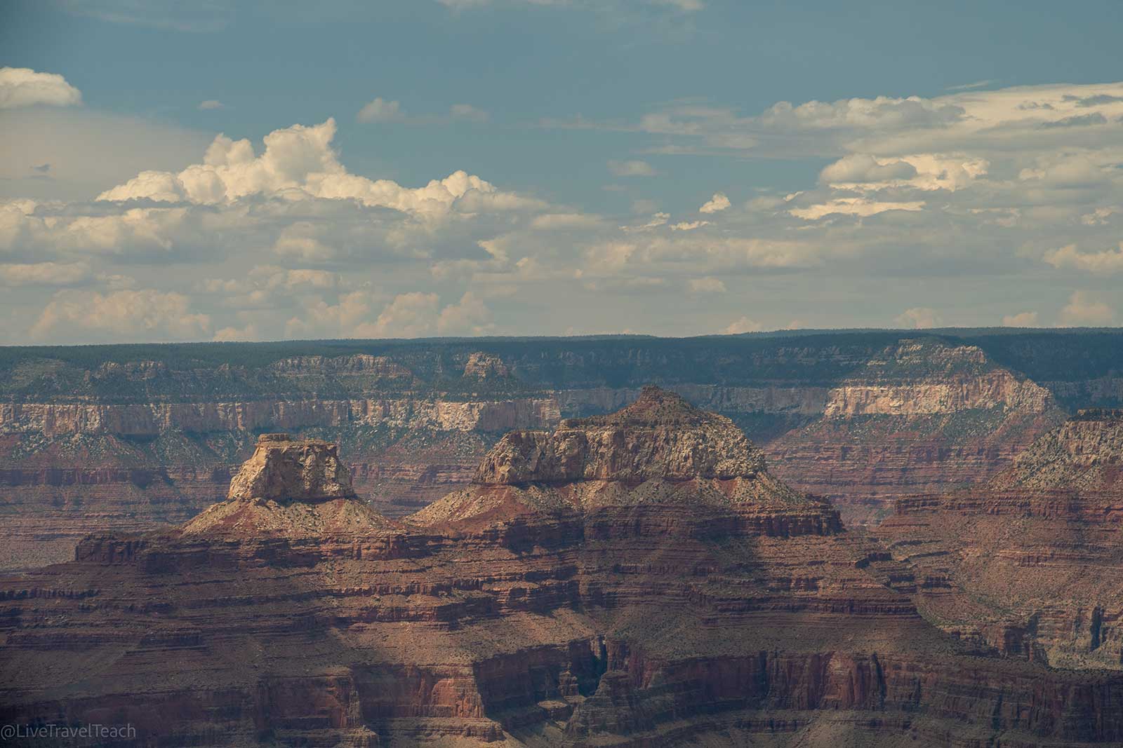Sunlit Grand Canyon seen from above with layered cliffs
