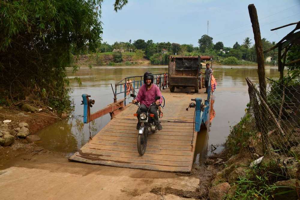 Motorbike crossing river by boat near Cat Tien National Park, wildlife and biodiversity in Vietnam