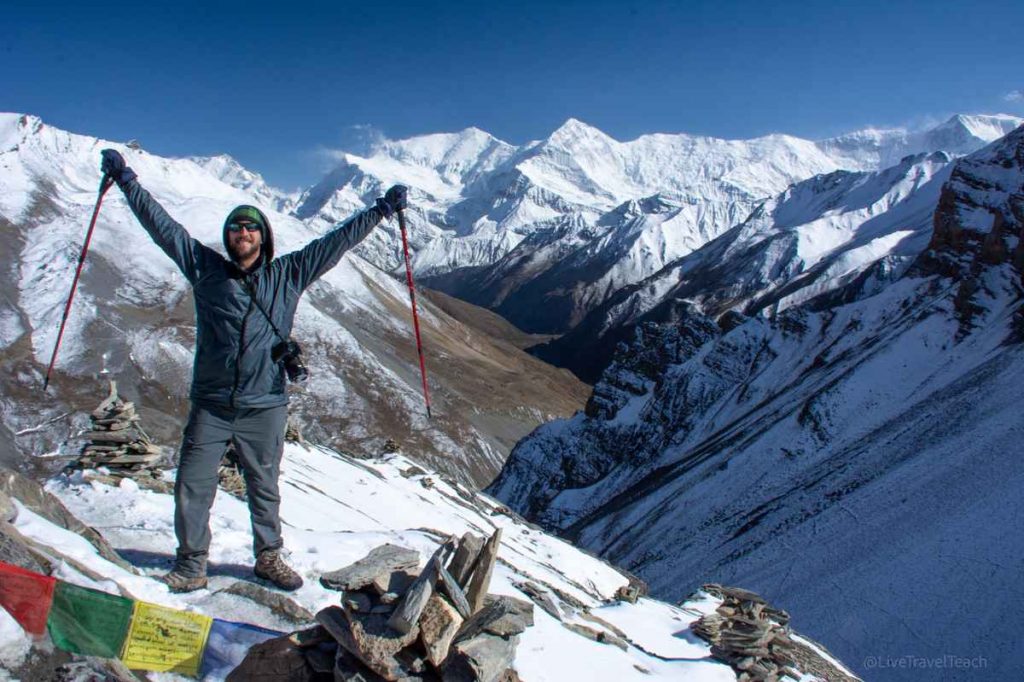 Man standing on a snowy mountain trail